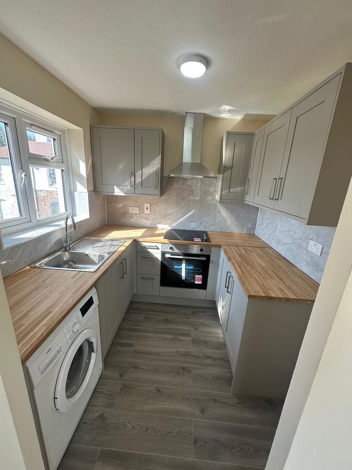 Grey shaker kitchen with oak-effect worktops